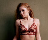 curly redheaded model with septum piercing wearing longling embroidery bralette lingerie