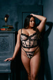 plus size light skinned black model wearing anbutterfly embroidery bustier and the matching gstring