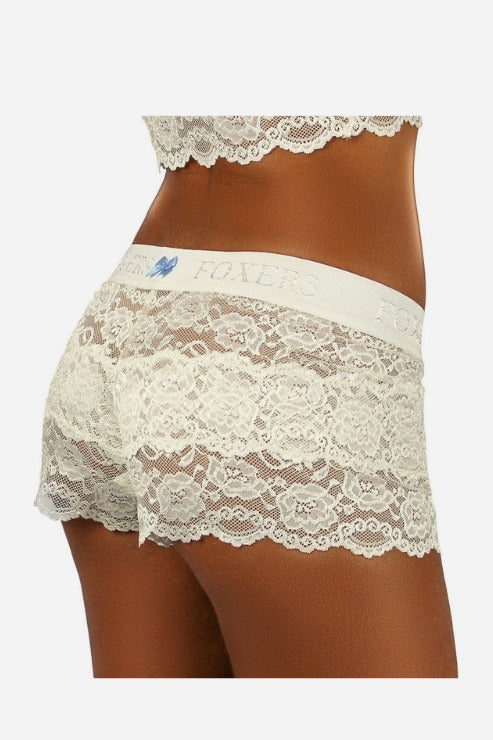 Back view of ivory Foxers lace boxers with scalloped lace legs, an ivory FOXERS waistband and a small light blue heart tag at the waist