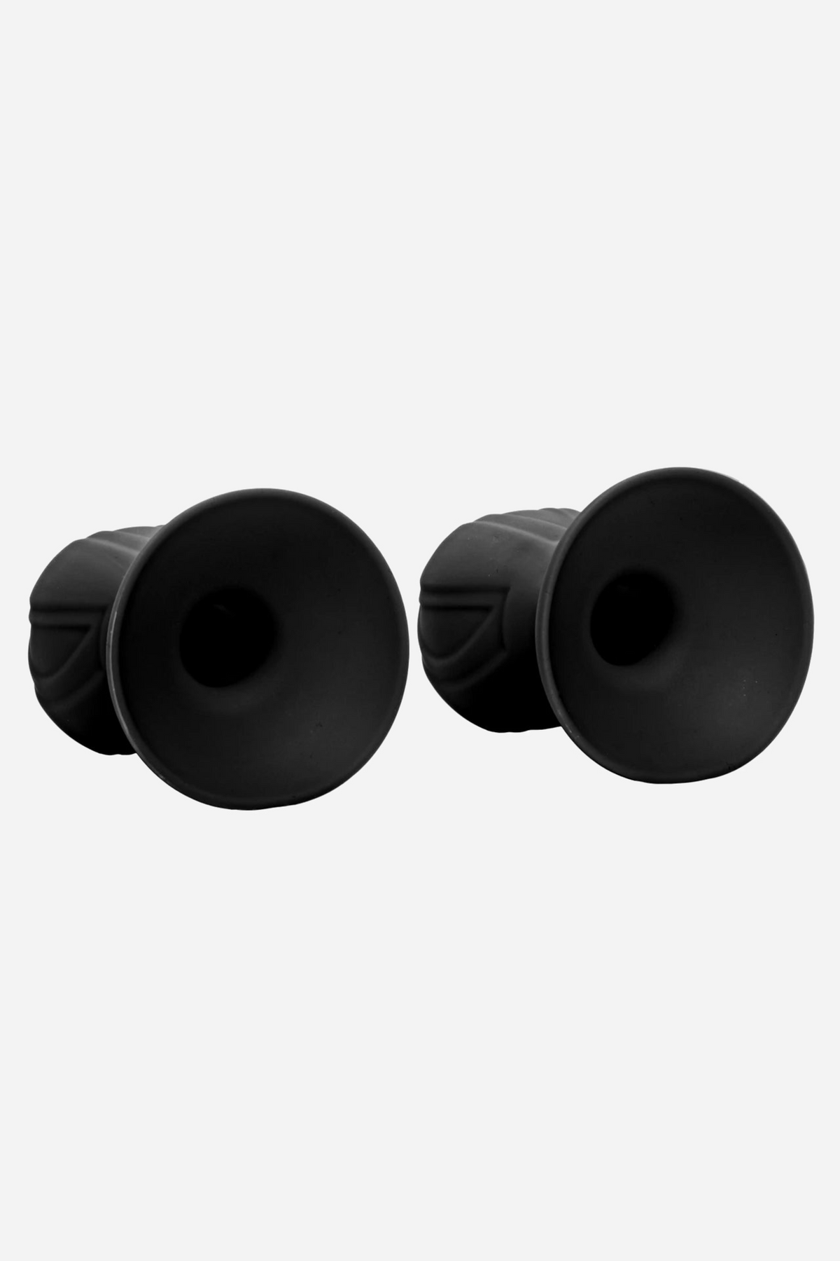 The pair of black silicone nipple suckers tipped on their sides, showing the deep open suction cups and the ribbed outer collars.