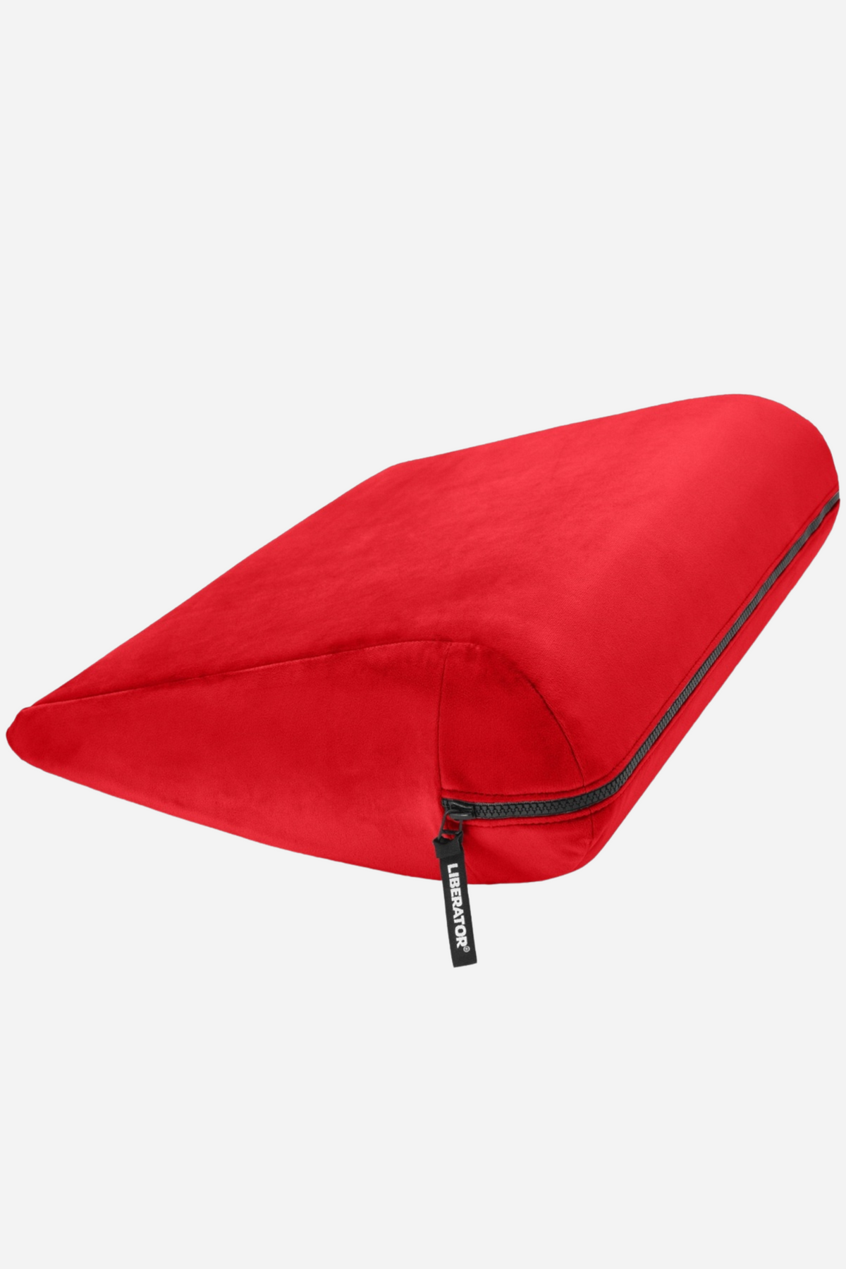 Liberator Jaz positioning wedge in bold red microvelvet, a compact sloped pillow with a zip-off washable cover, shown on light grey