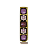 shows the pretty gift packaging with gold foil and the 5 pride themed chocolates lined up vertically