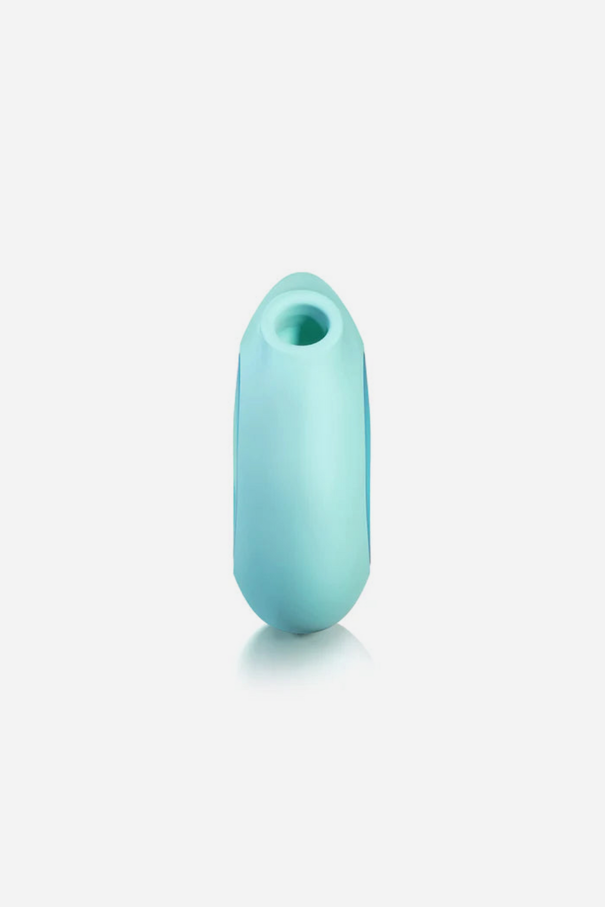 Side view of the mint Lumii standing upright with a soft reflection, showing the air pulse opening at the top of the slim silicone body
