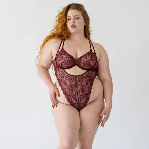 size xl white model wears a red lace teddy from monique morin