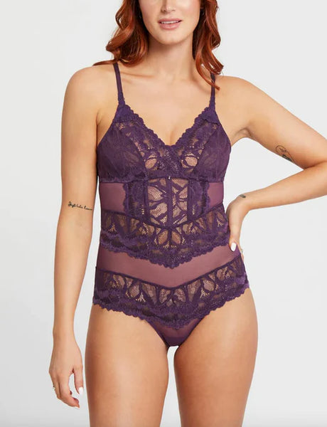 size small white, redheaded model shows off the purple lace Never Be Royale Bodysuit in Pinot Purple