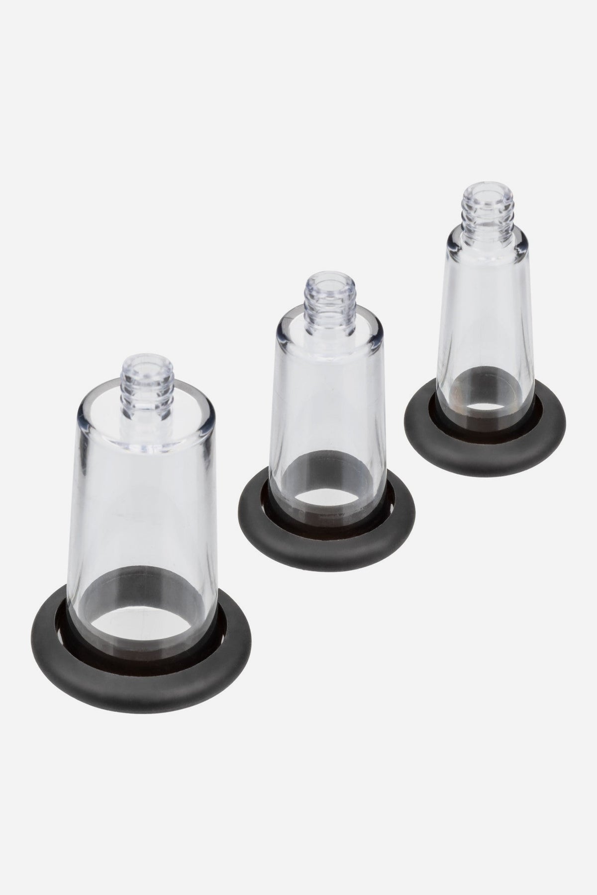 The three clear No Bounds pump cylinders in different sizes, each fitted with a soft black silicone base sleeve, on a light grey background
