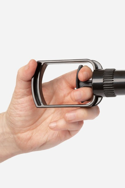 Hand squeezing the black pistol-grip pump handle of the No Bounds Trans Masc Pump, showing how the easy-grip trigger fits in the palm