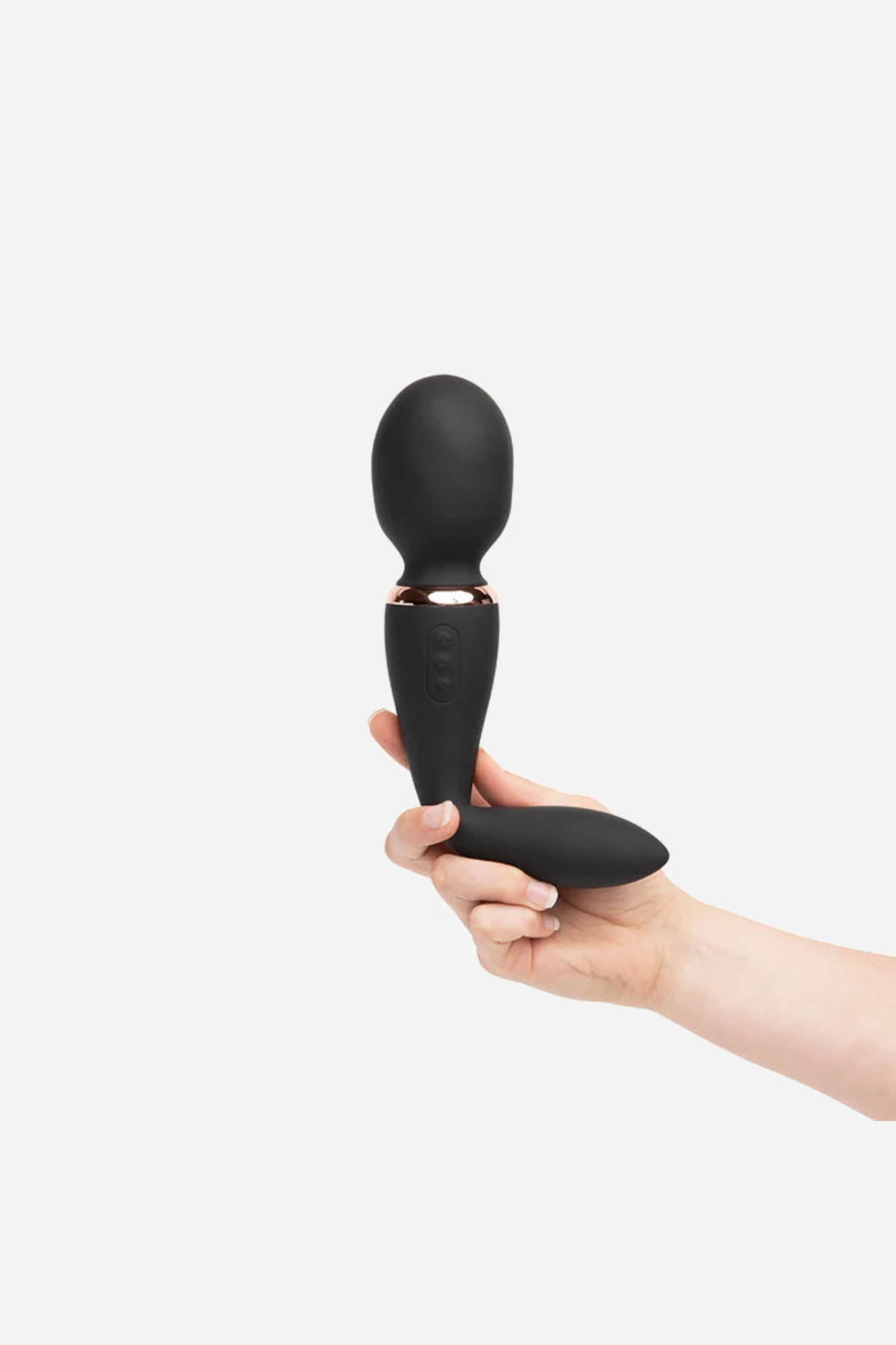 The black Alluvion wand held in a hand, showing the size of the rounded massage head against the palm and the slim curved shaft