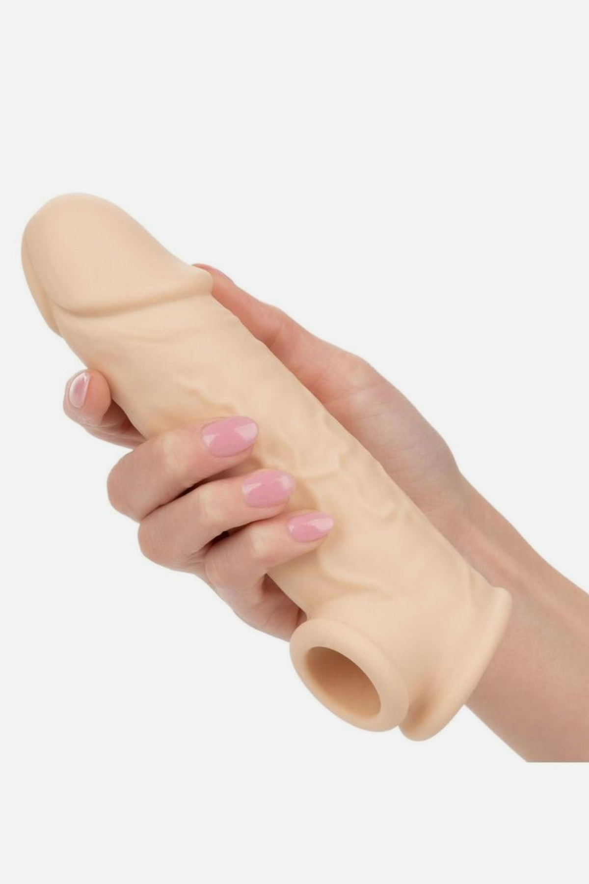 Hand holding the vanilla Performer Seven Penis Extender, showing the realistic veined shaft, defined head and open sleeve at the base