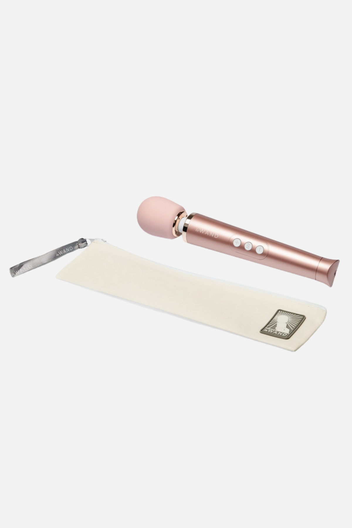 What's included with the Le Wand Petite: the rose gold wand, cream drawstring storage bag, charging cable and instruction card on grey