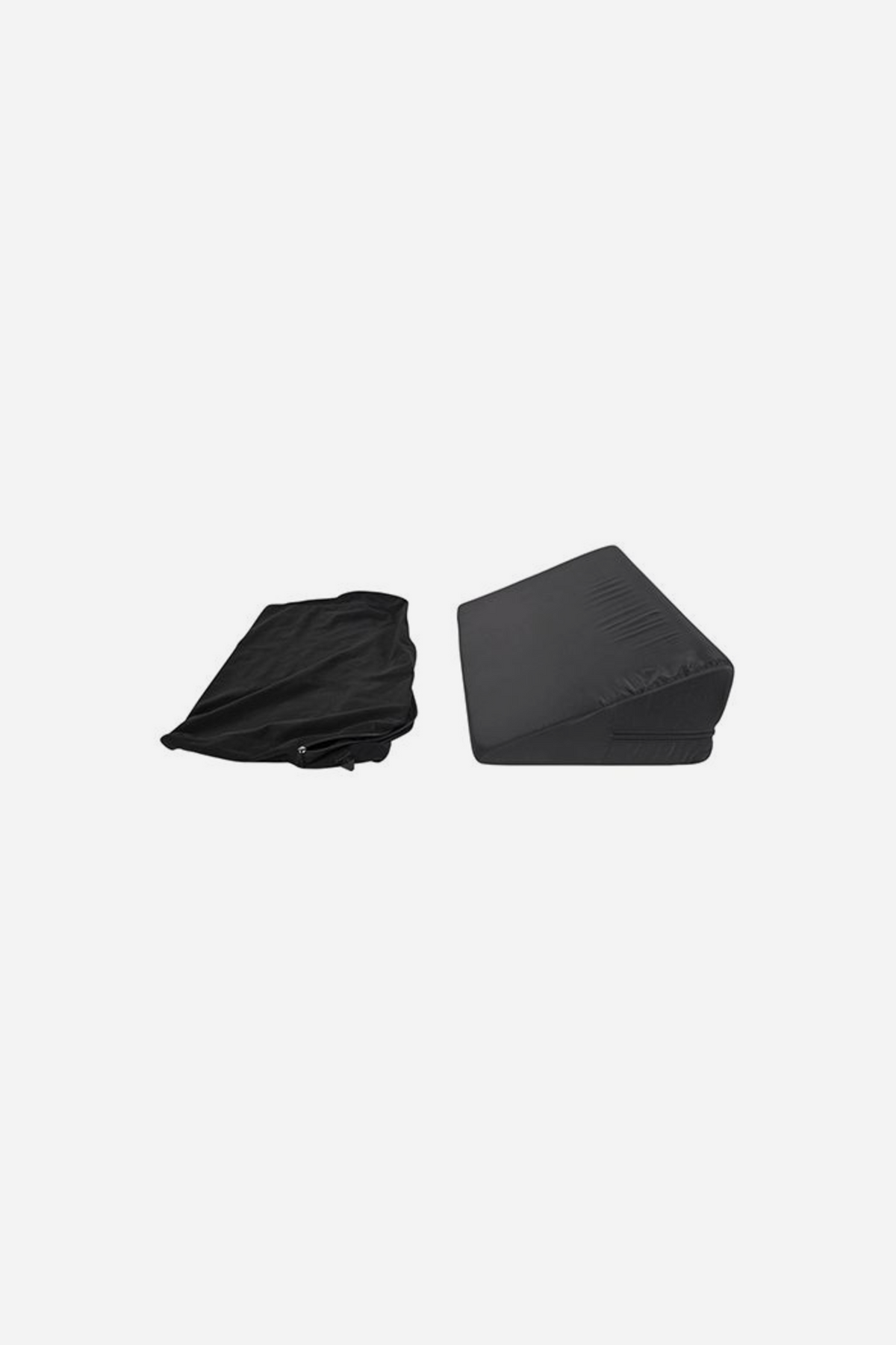 Black Pivot positioner wedge pillow on grey beside its removable soft cover, the firm triangular foam wedge shown standing on its long side.