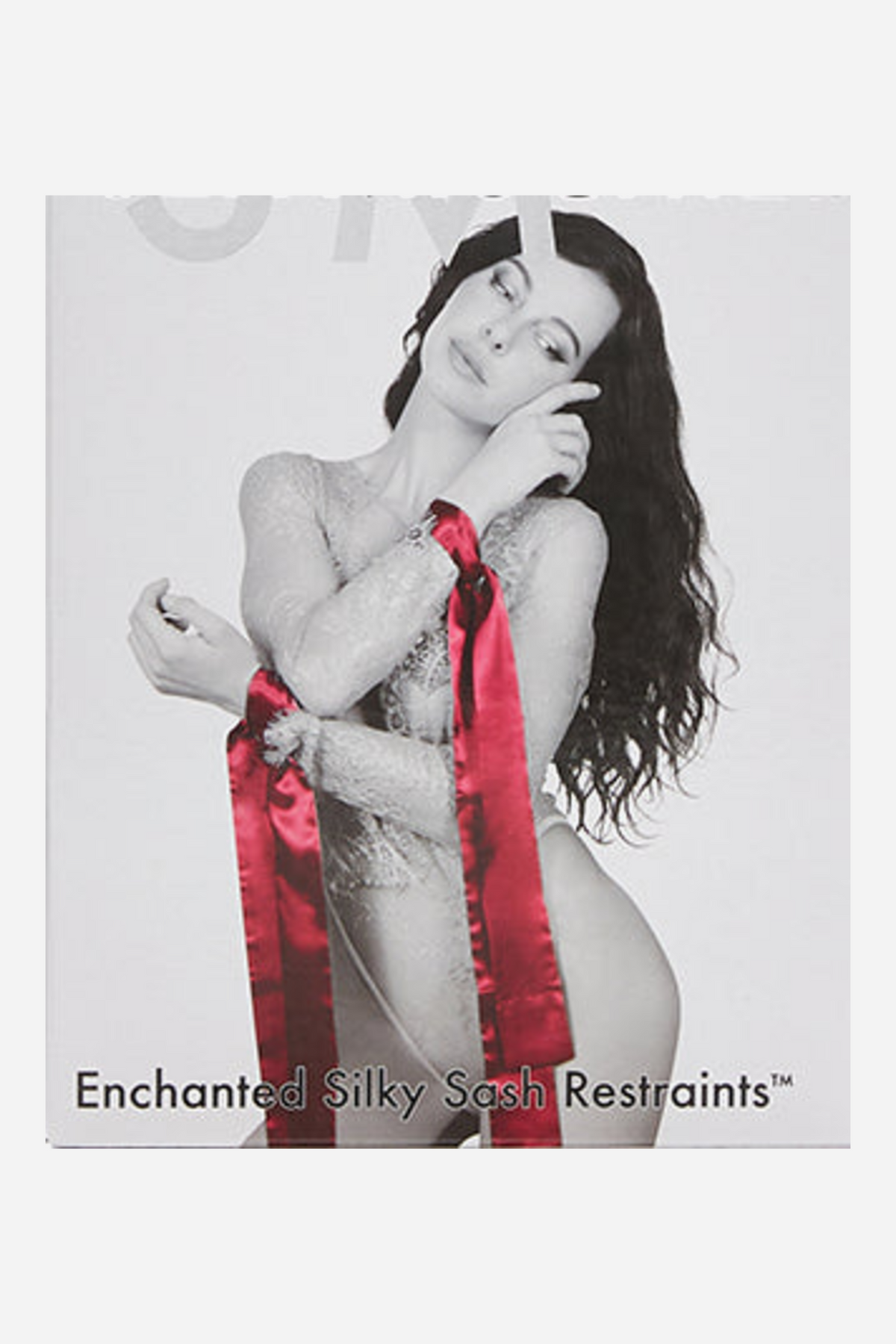 Front of the Enchanted Silky Sash Restraints box, a black and white photo of a model in white lace with red satin sashes tied around her crossed wrists.