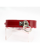 front view of a shiny patent red leather fetish gear collar lined with soft furry fleece. has a single o-ring in front