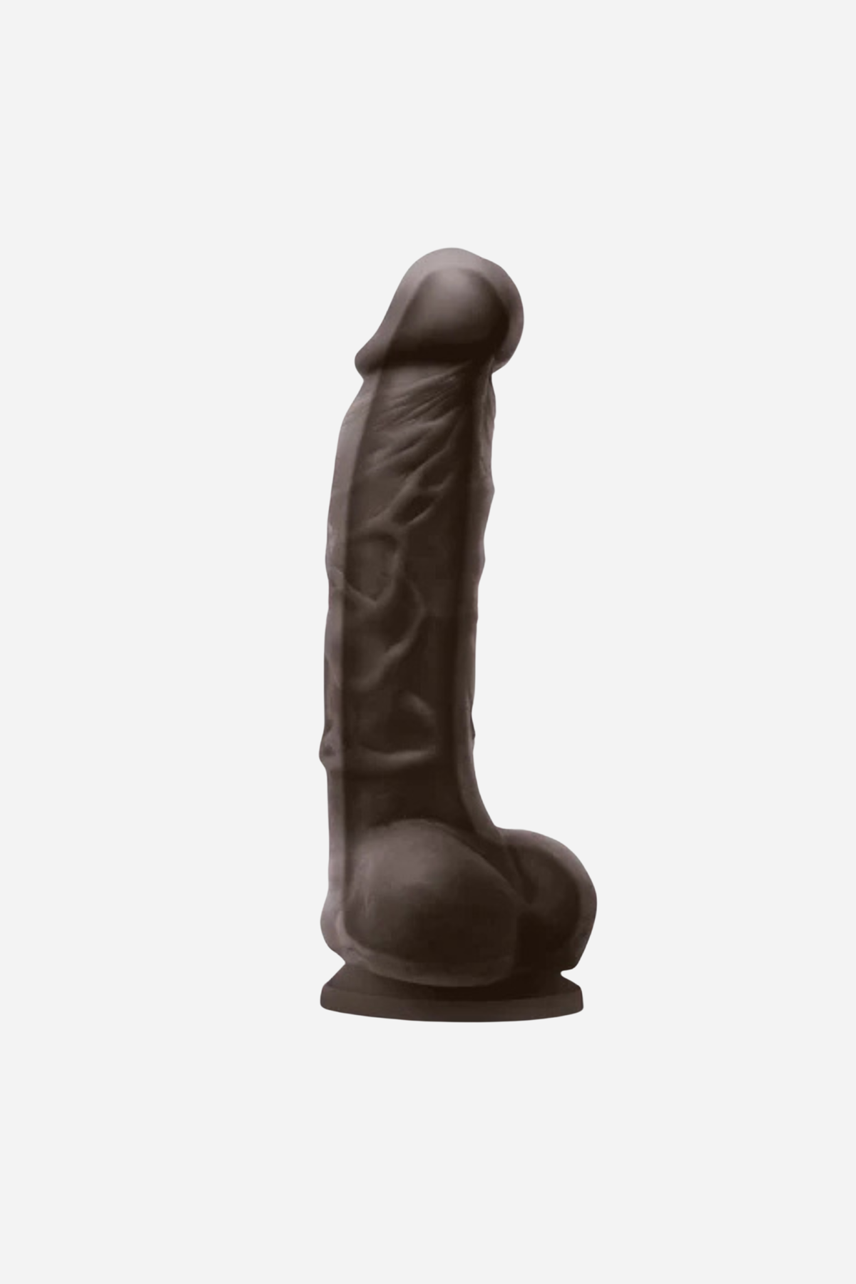 Pleasures 5 inch realistic dual density dildo in Chocolate, side view showing the veined shaft, balls and suction cup base on light grey