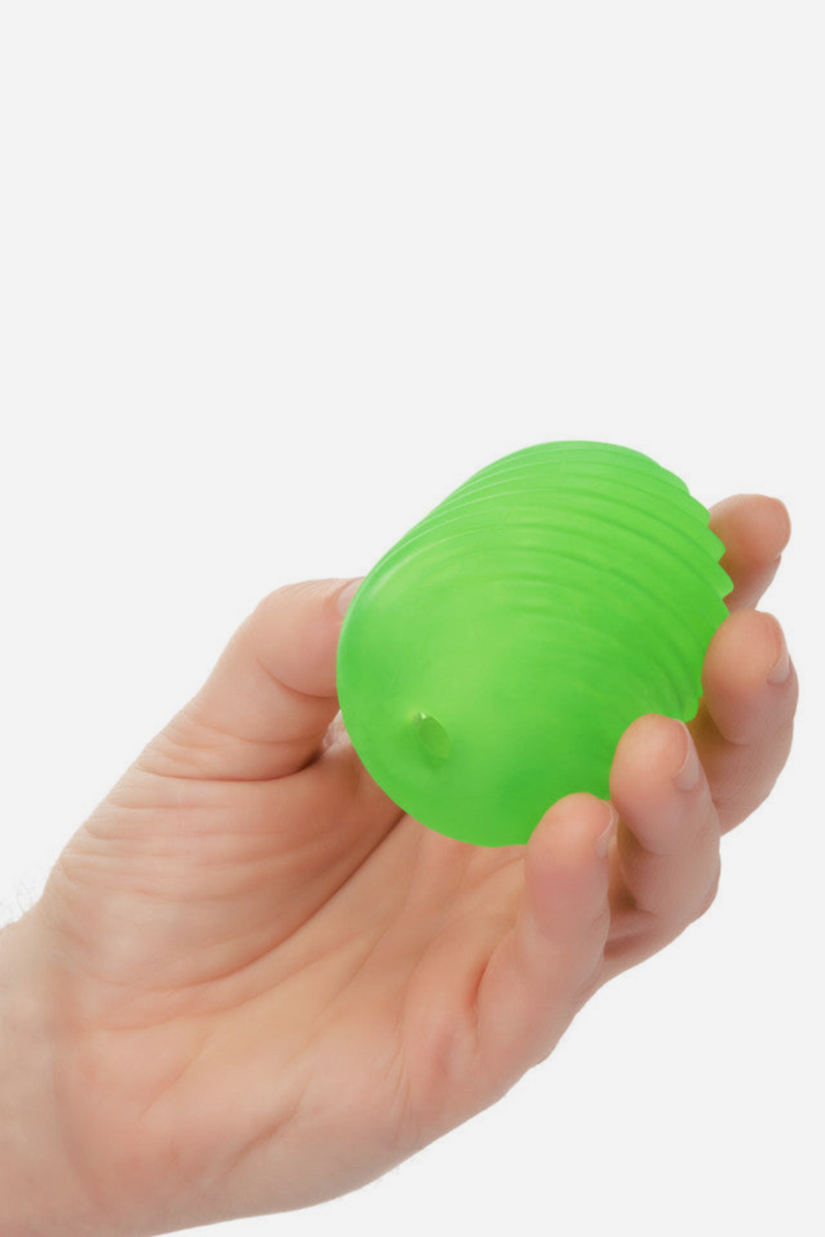 Hand holding the neon green Pop Sock Textured Stroker to show its compact, palm-sized shape and soft, stretchy textured body