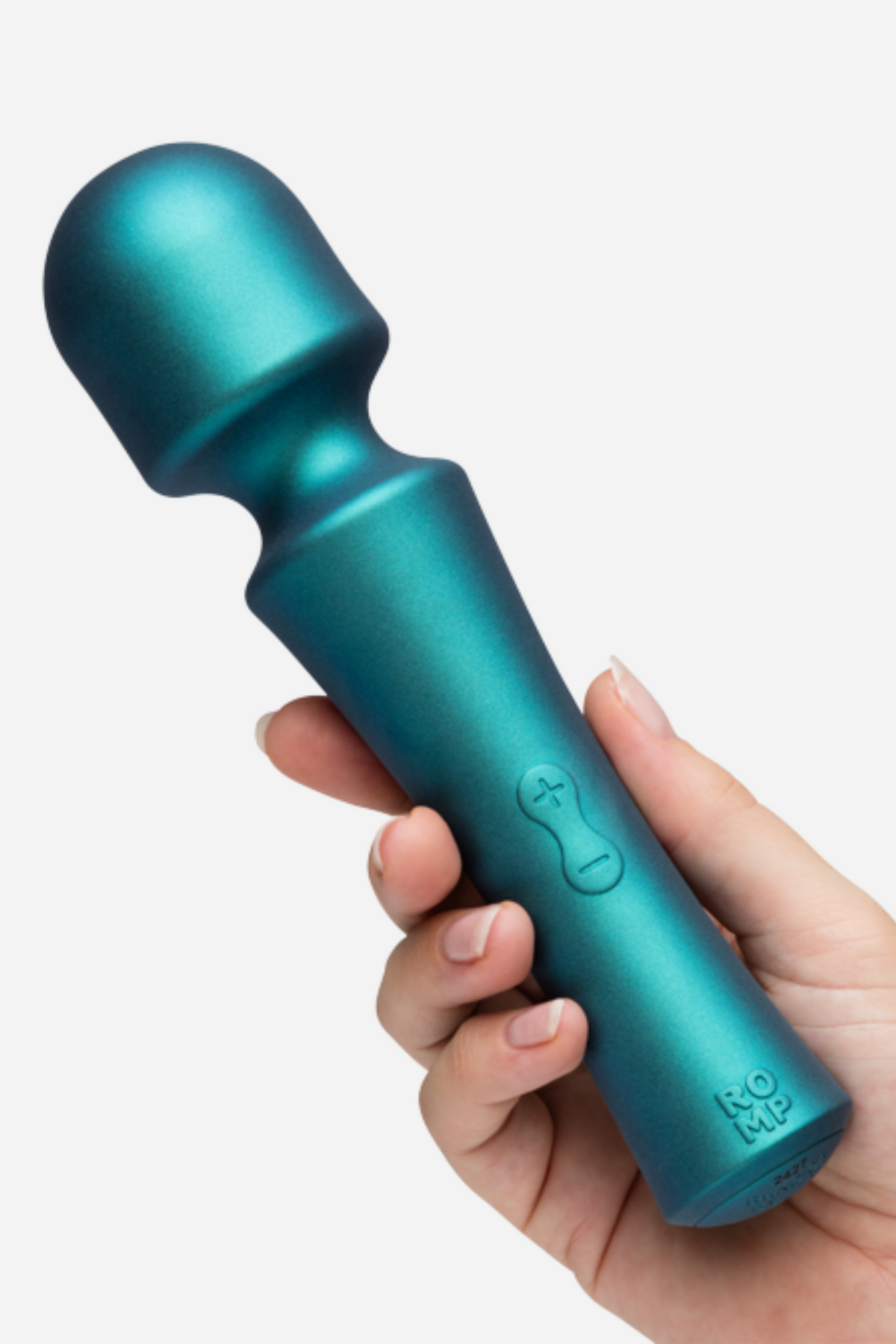 Romp Presto powerful mini wand in teal held in a hand, showing the rounded head, slim handle and control buttons on light grey