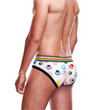 shirtless white male model turns away from camera to show off the art and design of the rainbow colored paw prints across the bum of the brief
