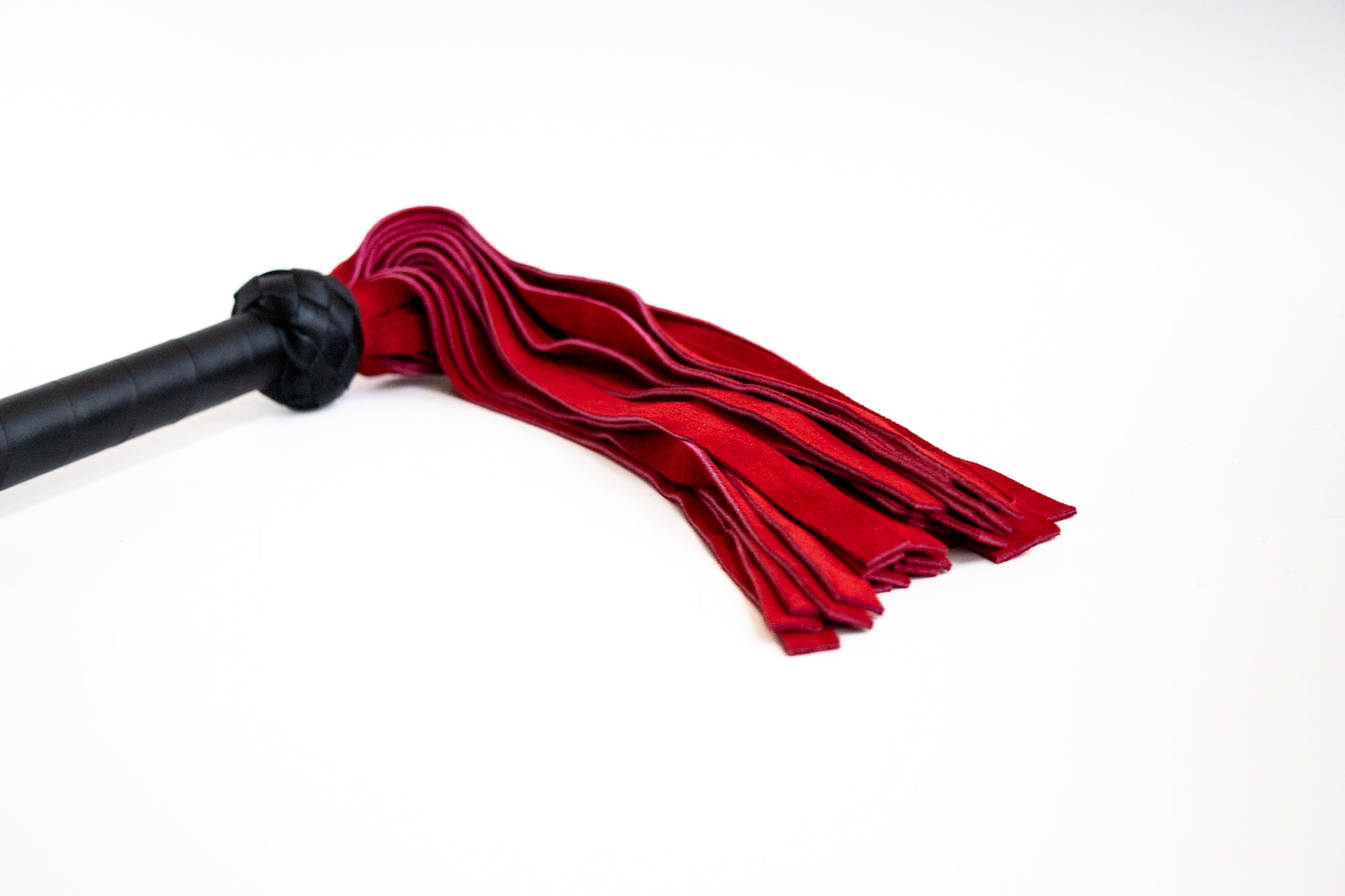 close up of the suede flogger falls in beautiful red color