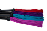 close up of the four different color suede kinky floggers. shows the width of the falls