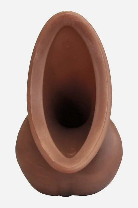 Top-down view into the oval funnel of the Dark Caramel Realistic STP device, showing the hollow channel and soft silicone