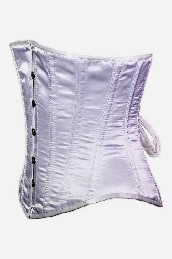 Side view of the white satin Satin Doll underbust corset showing its hourglass waist curve, flared hip panels and white lacing ties at the back
