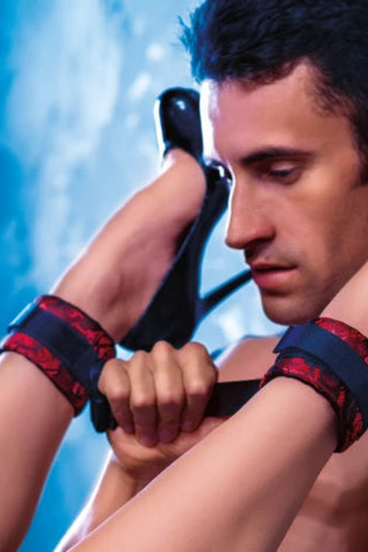 Close-up of the Scandalous Brocade Cuffs fastened around a partner's ankles and wrists, linking them for deeper, controlled positions