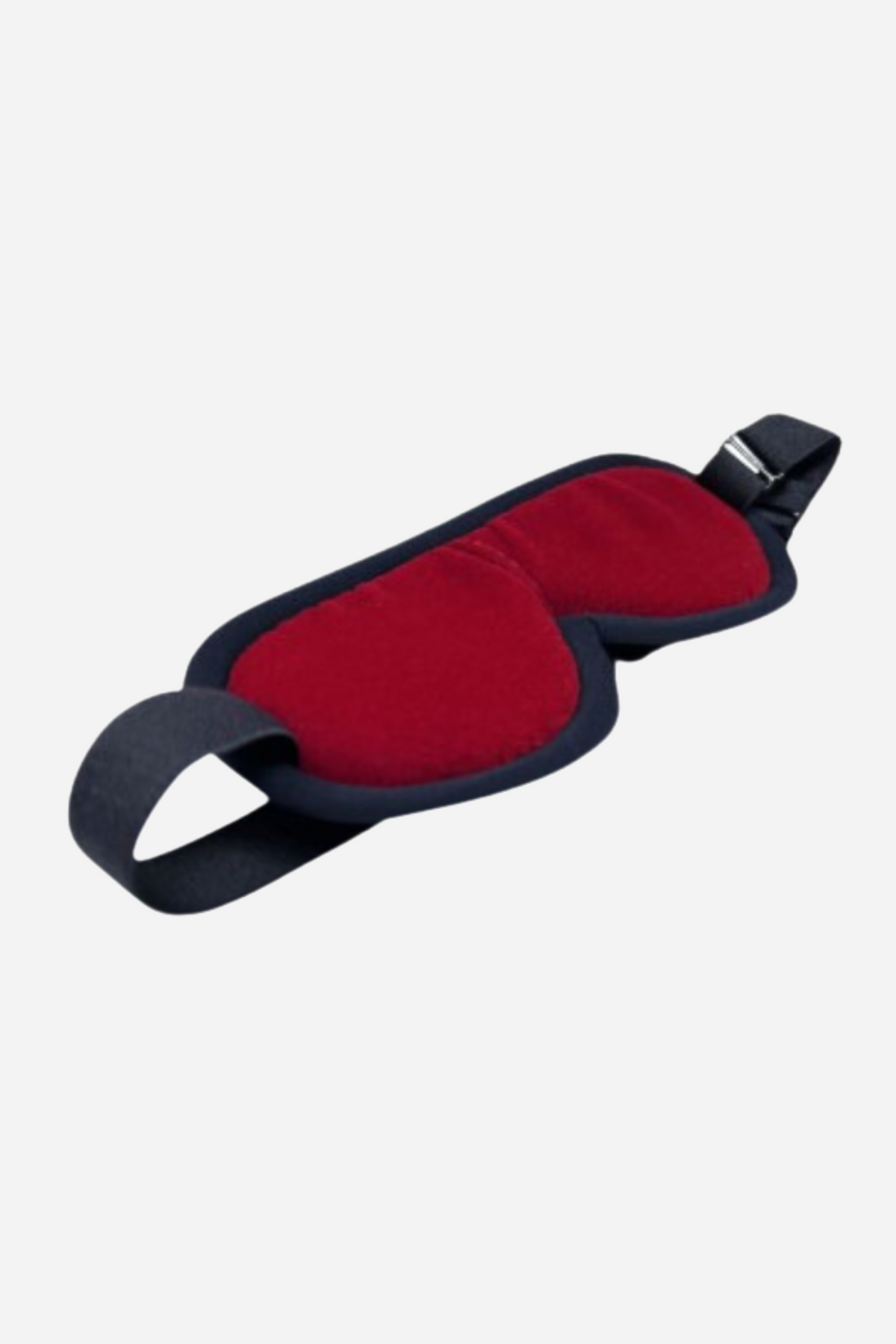 A padded blindfold with a deep red velvet face and black leather trim, its wide black elastic strap curving away to one side.
