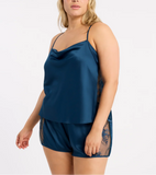 size 2x plus size blonde model wears elevated loungewear cowl neck cami set and matching tap shorts in a celestial blue color