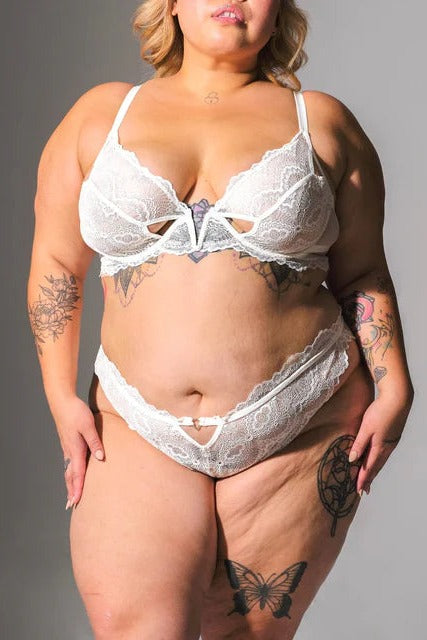 Plus-size model in the Sugar & Kane crotchless bikini in ivory lace with a matching ivory lace plunge bra, full front view