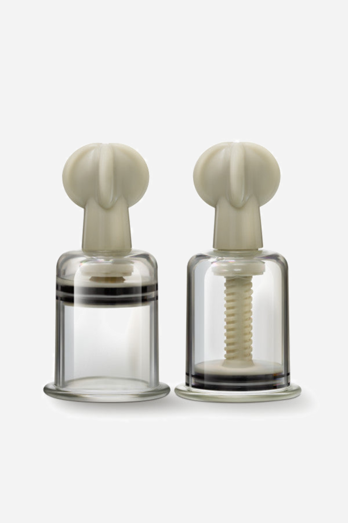 Tempt Me large twist nipple suckers, a pair of wide clear cylinders with cream twist tops, one cut away to show the inner screw.