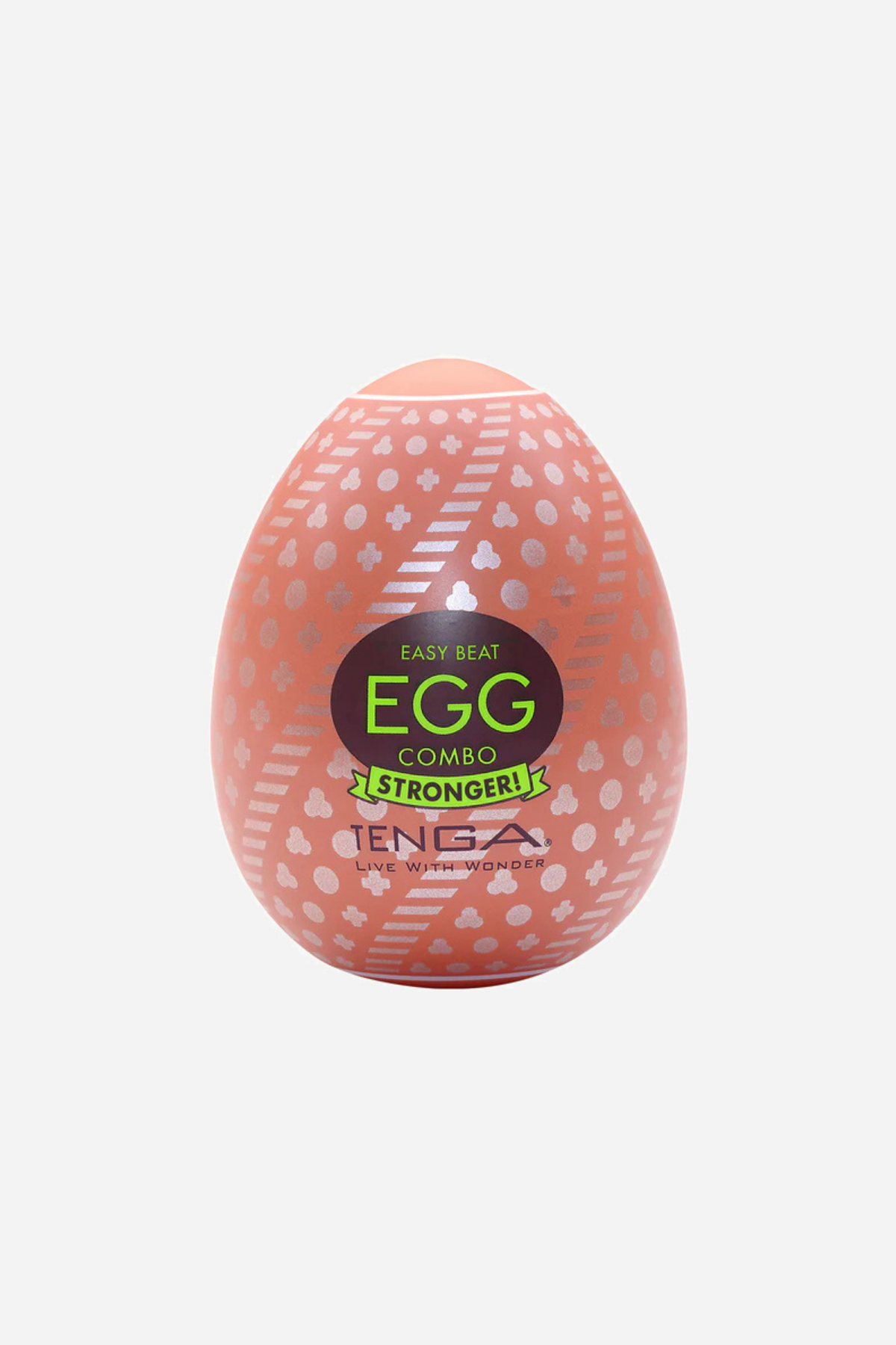 A coral pink Tenga Egg stroker in its moulded shell, printed with a raised honeycomb pattern and a green and black EGG label on the front