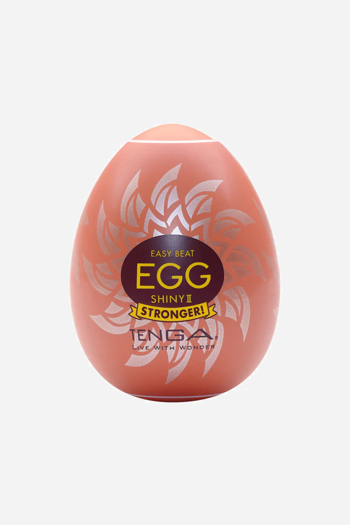 A coral pink Tenga Egg stroker with a swirled embossed shell and a yellow and black EGG label, standing upright on a plain background
