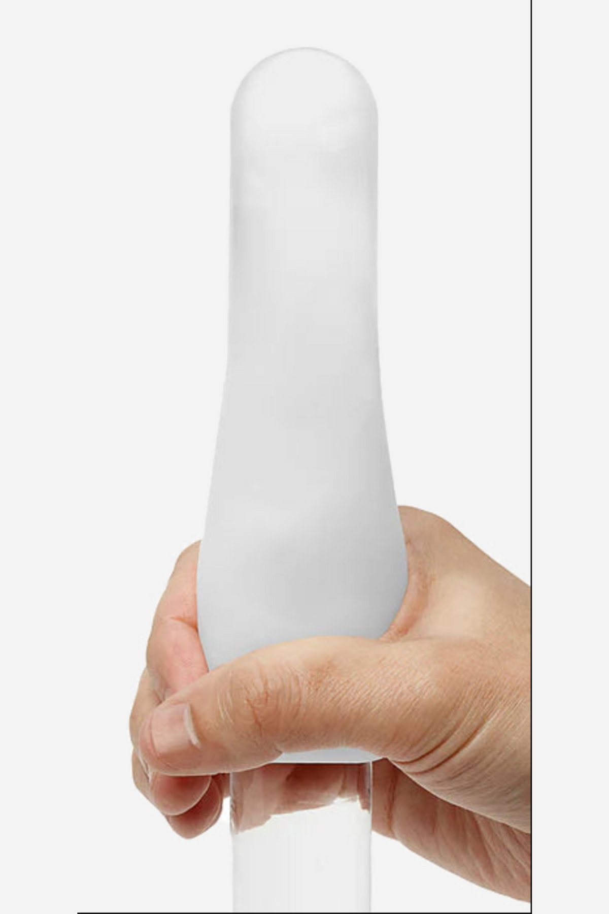 The soft white Tenga Egg sleeve stretched over a hand, showing how far the elastic material expands from its small egg sized shell