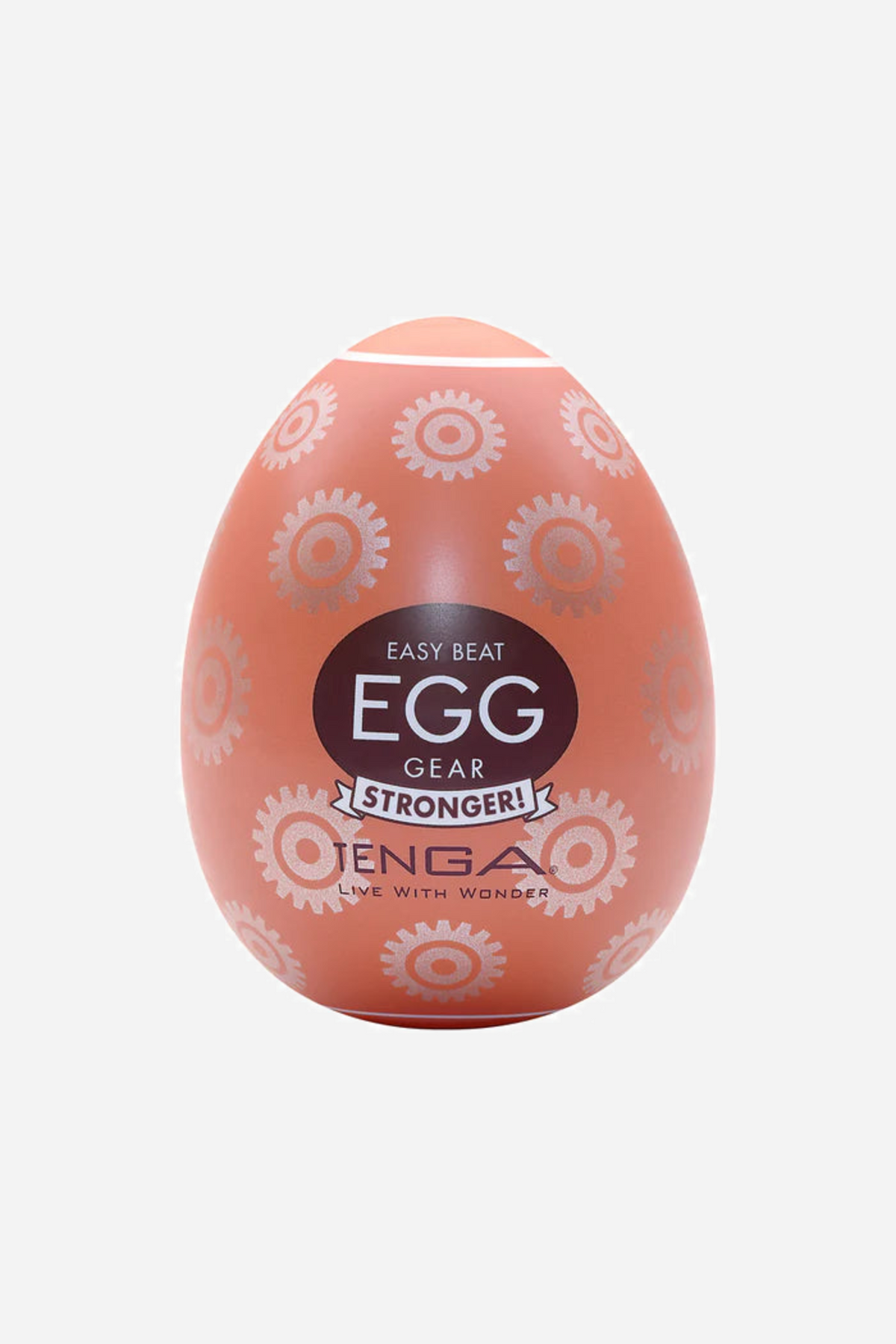 A coral pink Tenga Egg stroker with a shell of raised circles and swirls and a navy and white EGG label, standing on a plain background