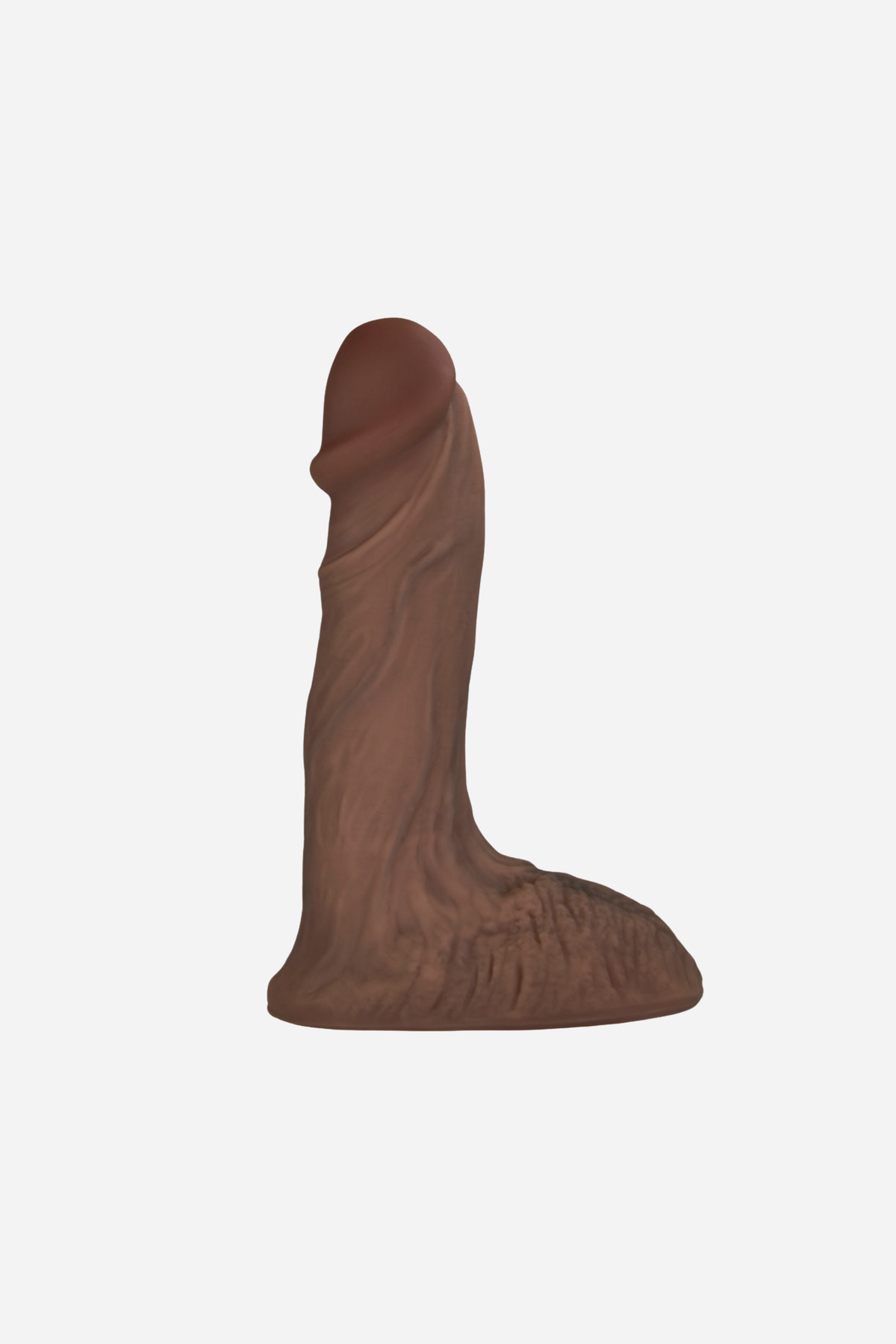 The Ultimate 6 inch ultra realistic silicone pack and play dildo in Mocha Dark Caramel, side view of the veined shaft and balls on light grey