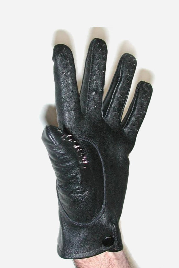 Hand wearing a black leather vampire glove with spiked palm-side fingers, stitched seams and a snap closure at the wrist