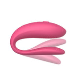 pink sync lite with shadows above and below the insertable end. meant to show that the toy is flexible on the bottom, insertable arm. This toy doesn’t have a hinge so its flexible but not adjustable