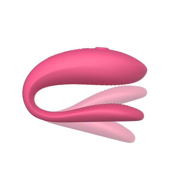 pink sync lite with shadows above and below the insertable end. meant to show that the toy is flexible on the bottom, insertable arm. This toy doesn’t have a hinge so its flexible but not adjustable