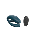 c-shaped hands-free wearable we-vibe sync o vibrator in green velvet color and a black external remote