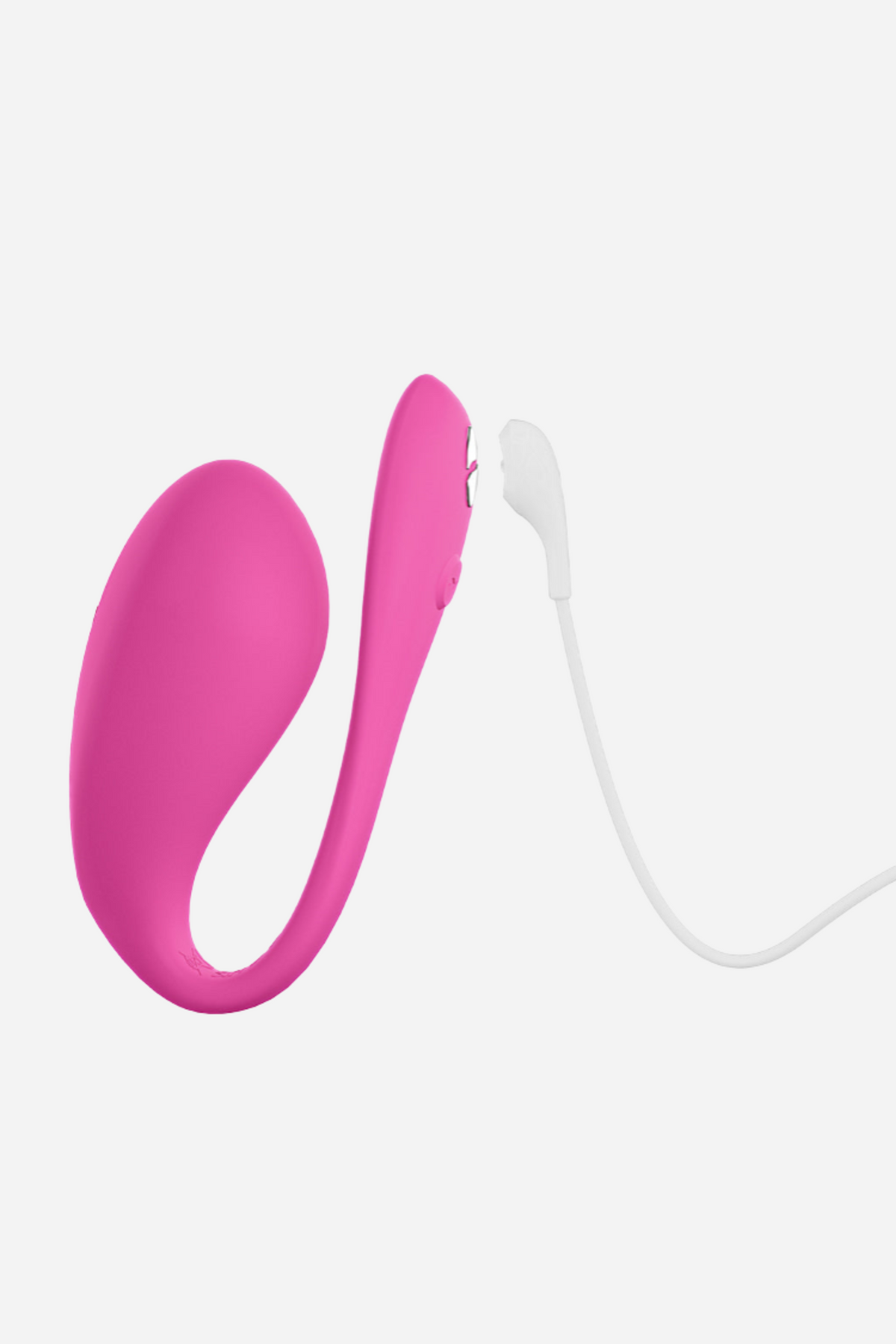 We-Vibe Jive 2 in electric pink beside its white magnetic charging cable, which clips onto the charging contacts on the tail