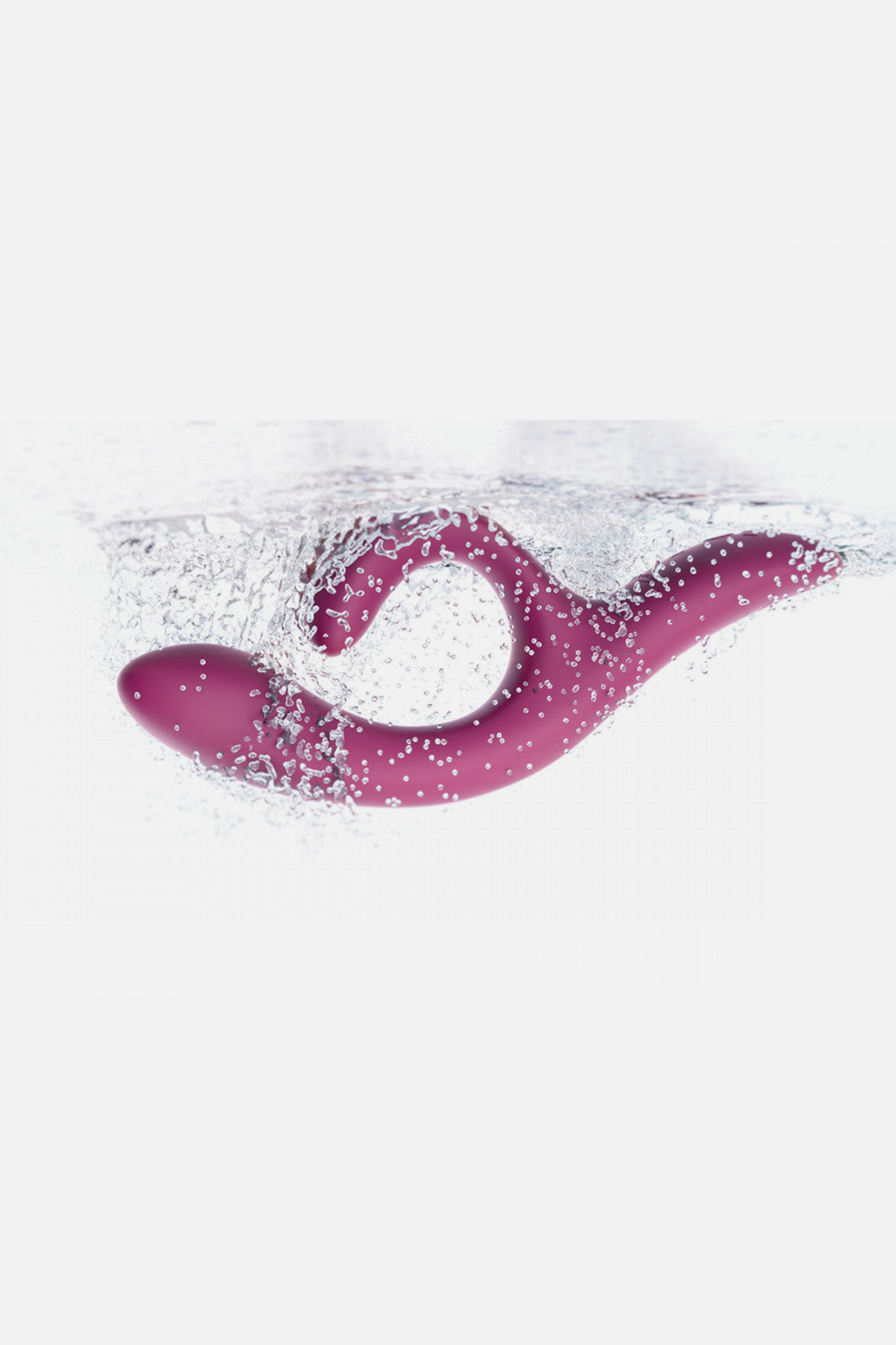Magenta We-Vibe Nova 2 Rabbit Vibe surrounded by water splashes, highlighting its fully waterproof design for bath or shower play