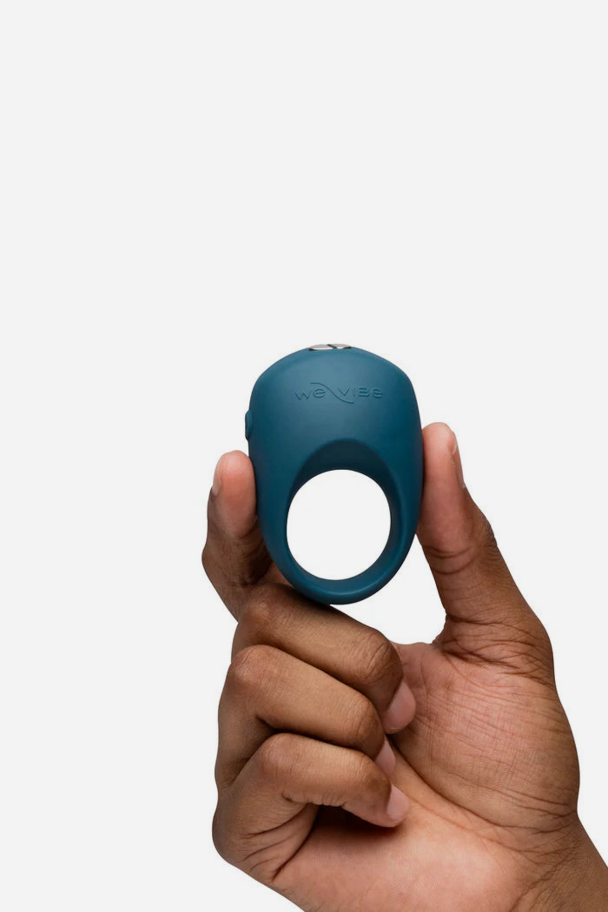We-Vibe Pivot 2 vibrating C-ring in slate blue held up between finger and thumb to show its small size, on a light grey background