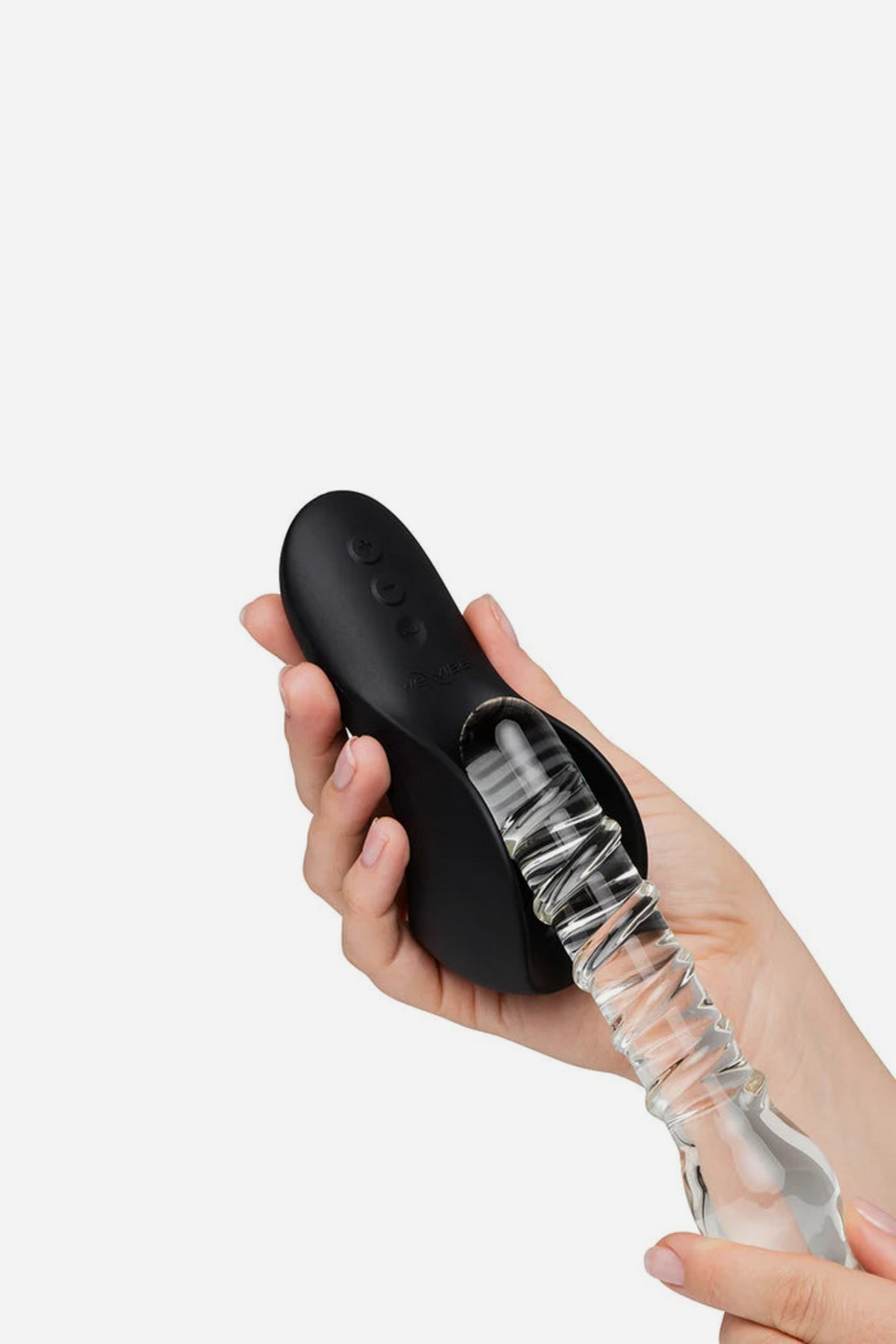 Hand holding the black We-Vibe Shared Touch couple's vibe with a clear textured toy pressed against its ribbed underside to show shared play
