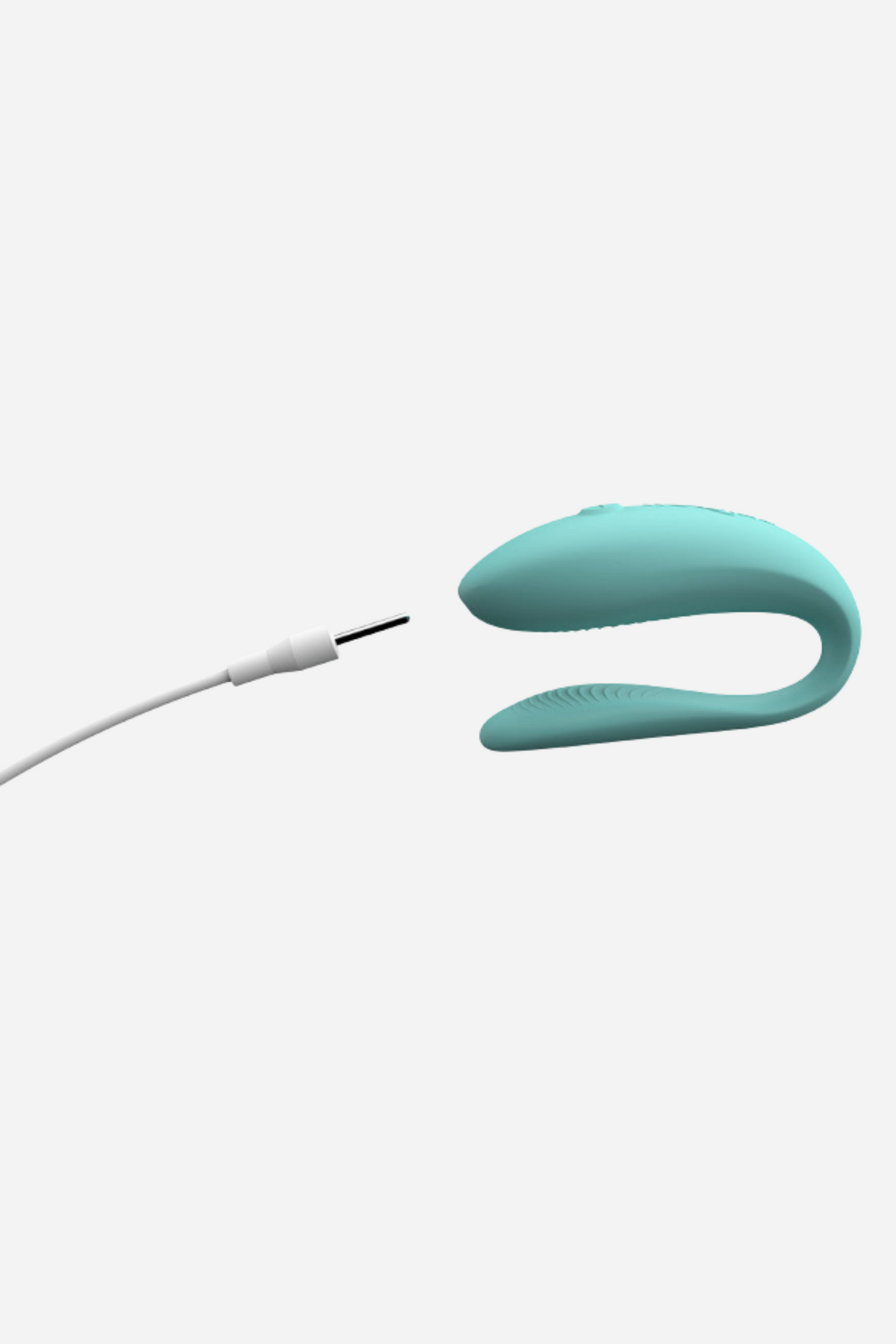 We-Vibe Sync Lite couples vibrator in Aqua next to its USB charging cable, showing the magnetic charging point on light grey