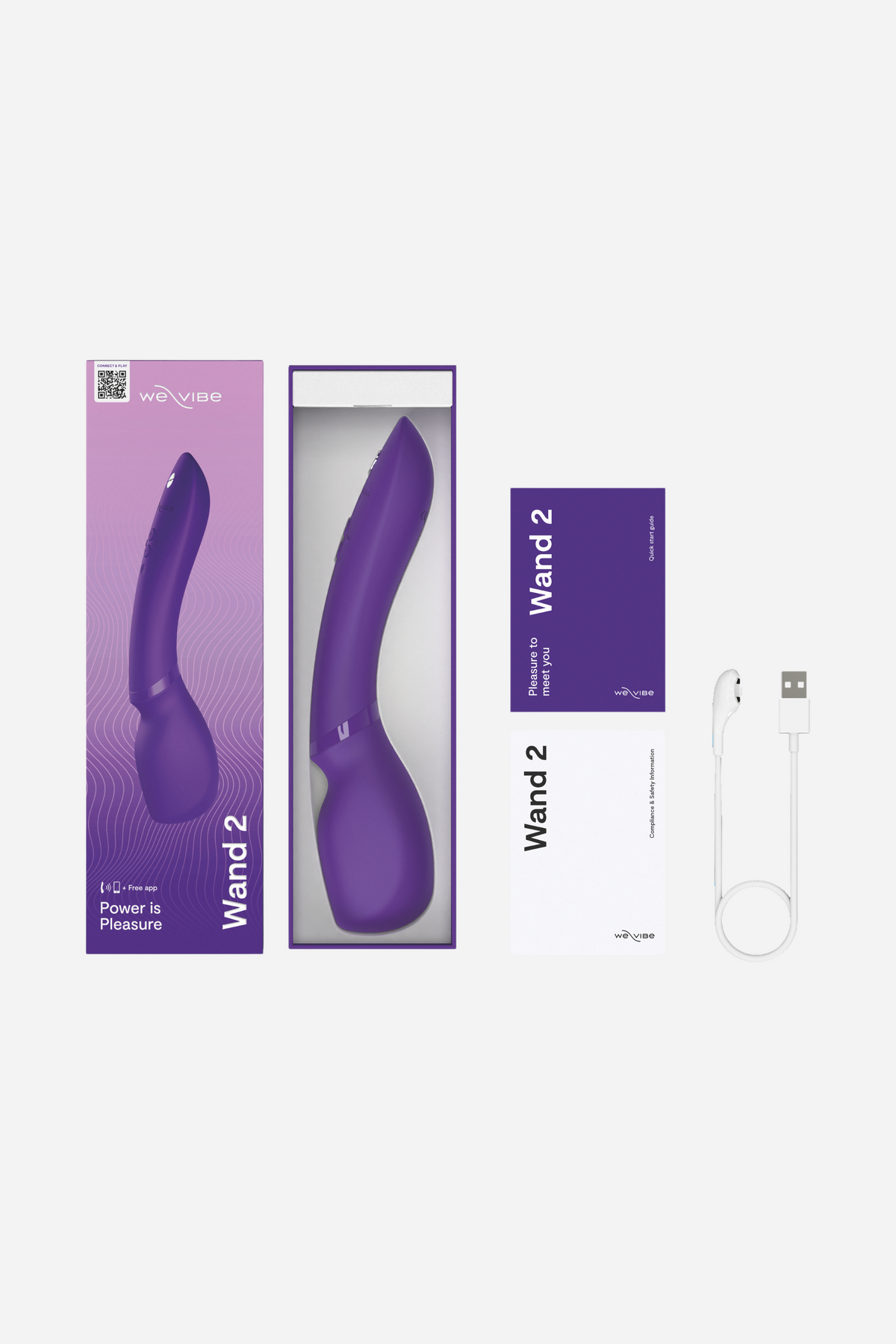 What's in the box: We-Vibe Wand 2 packaging, the purple wand in its tray, instruction booklets and USB charging cable, laid out on light grey