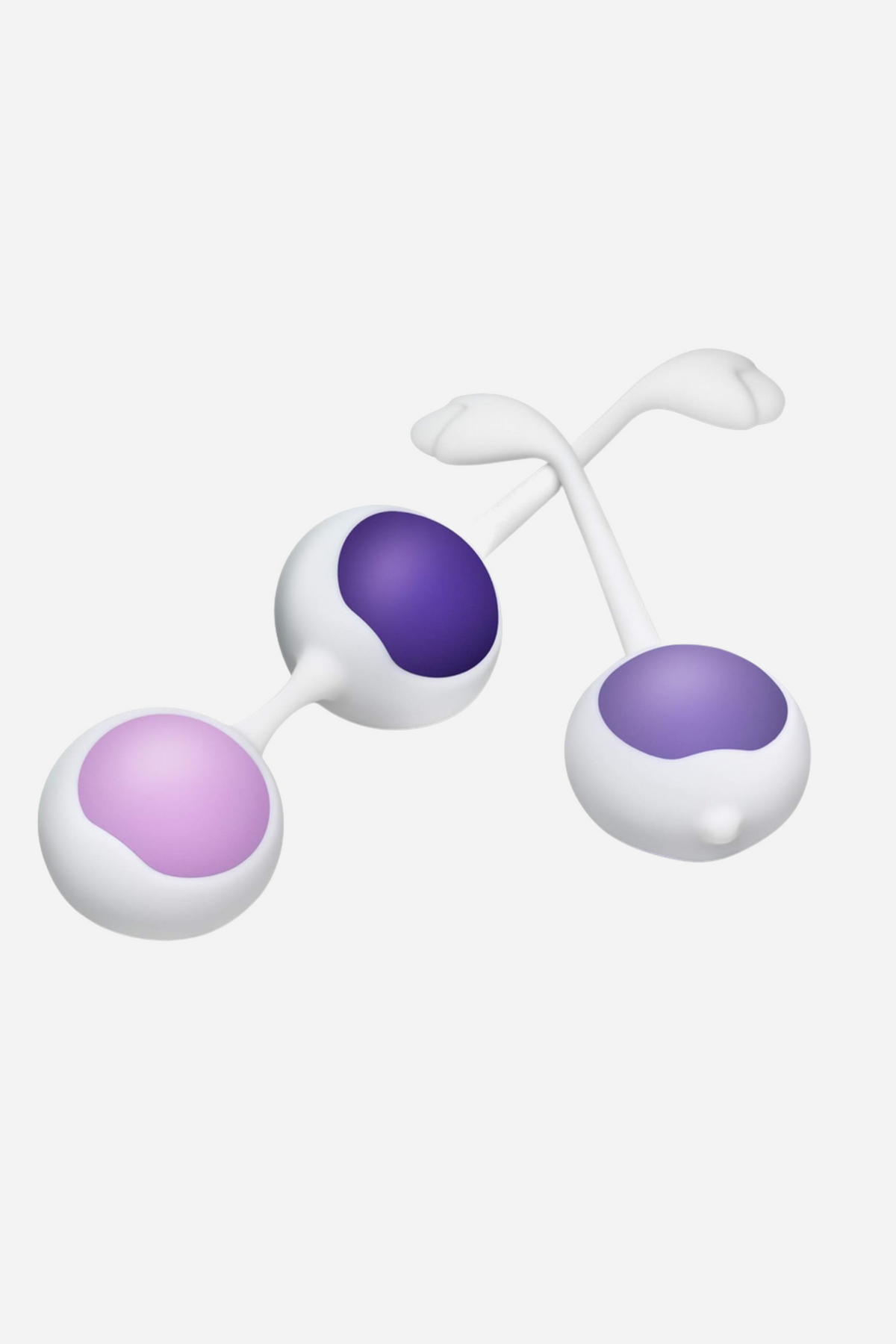 Three kegel balls with white silicone shells and retrieval cords, weighted in pale lilac, mid purple and deep purple, on a grey backdrop.