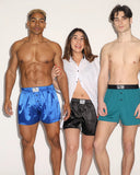 image of three people, black man, white woman, and white man wearing the adam smith boxers. the black man and white woman are wearing the silky boxers