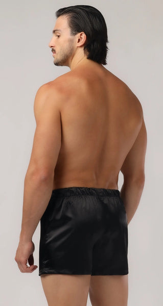 white model shows off the back of the silk black boxers mens lingerie
