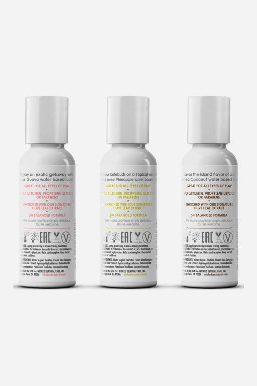 Back labels of the three Wicked Simply tropical lube bottles showing directions, ingredients and recycling symbols in pink, yellow and brown text