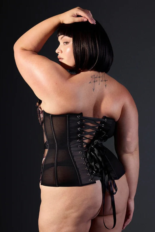 Curvy model seen from the side and back in the Wild Chanterelle Dreams corset, one hand on her head, showing the black ribbon lacing and mesh back panel